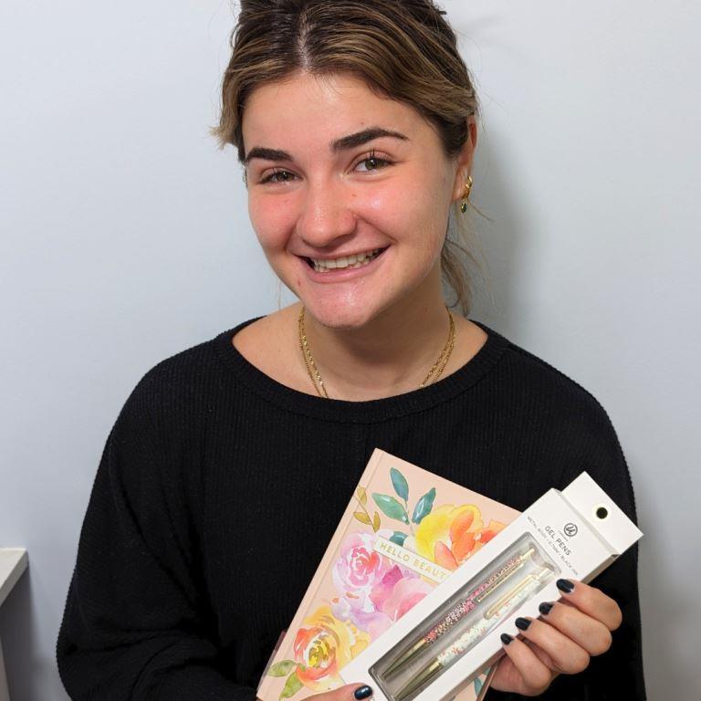 Best Cosmetic Dentist Miami Deering Dental in Palmetto Bay, near Pinecrest guest Izzy with a gift after treatment